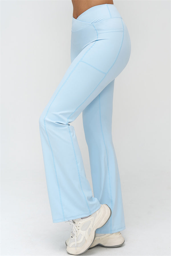 Light blue flared leggings with curved seams, full length