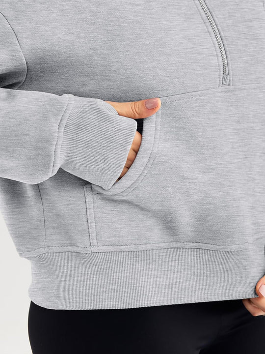 Grey hoodie cuff and front kangaroo pocket opening, relaxed oversized fit