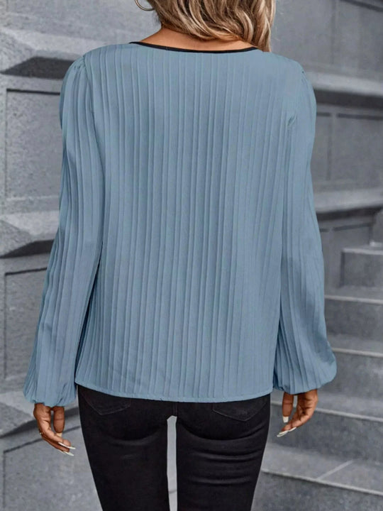 Powder blue textured blouse with long sleeves and pleated back