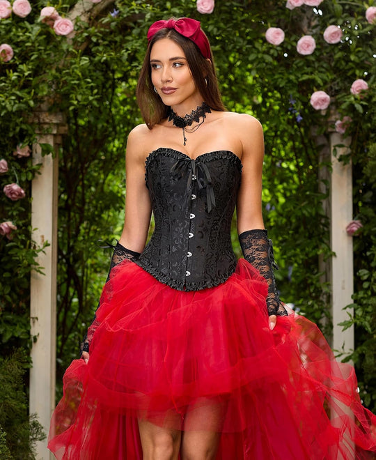 Black strapless corset with sweetheart neckline, lace-up front, paired with red tulle skirt
