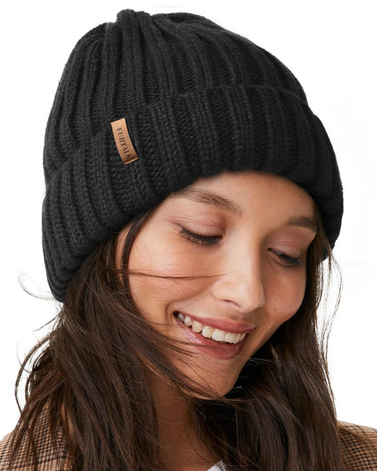 Fleece-lined chunky knit beanie in dark charcoal black with leather patch