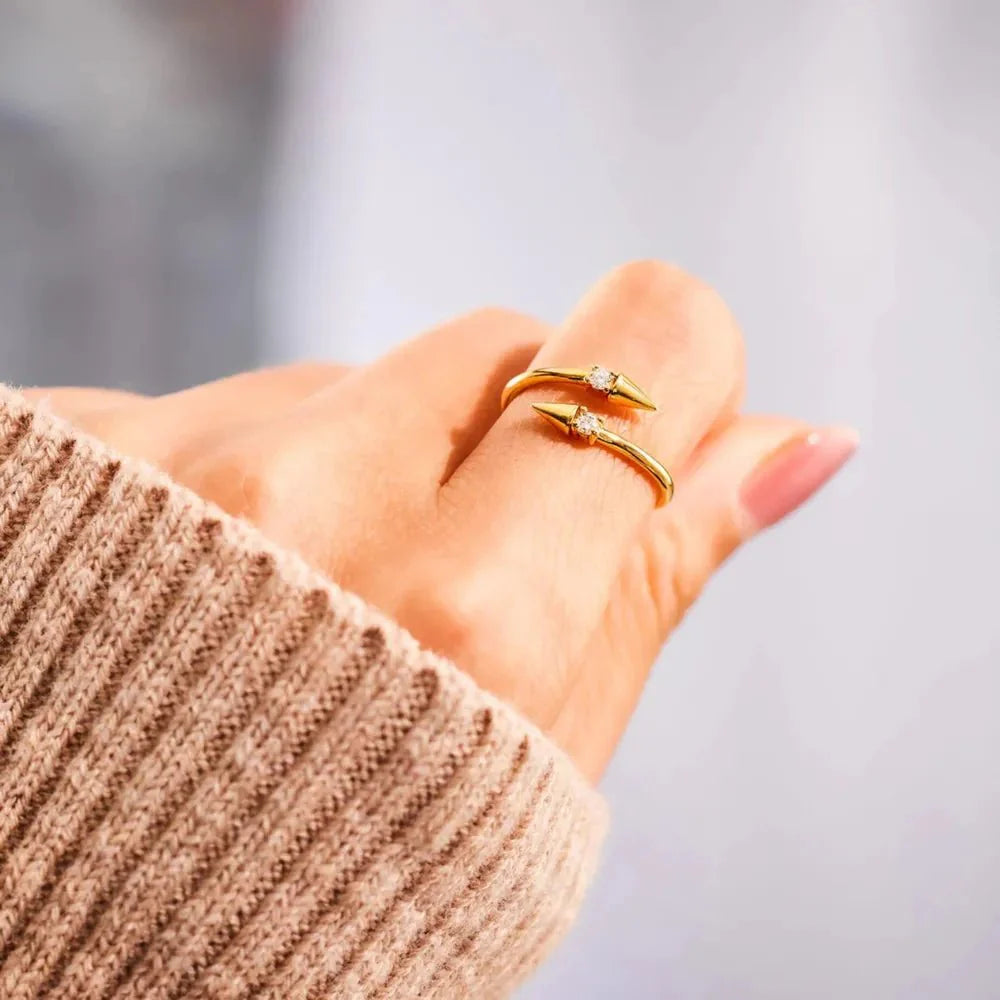 Gold Arrowlight Ring on finger, arrow-shaped setting with round crystal