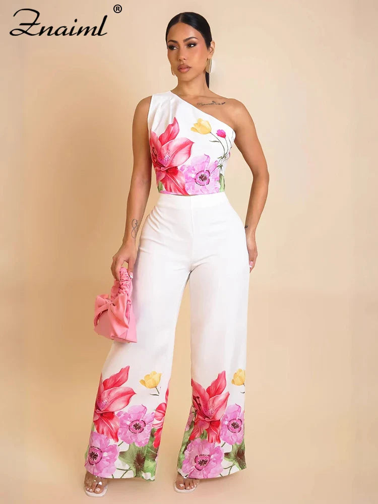 Flower print two-piece set: one-shoulder crop top and wide-leg pants, white with pink blooms