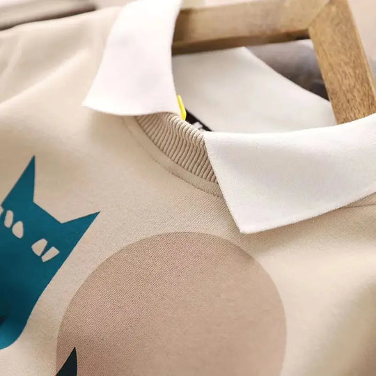 Beige hoodie collar and ribbed neckline with partial colorful cat print