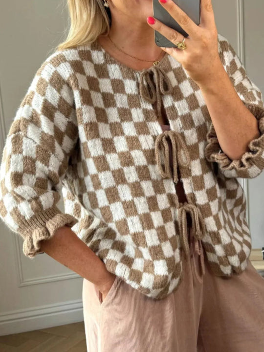 Tan and white checkered tie-front knit cardigan with drawstring neckline and ruffled cuffs