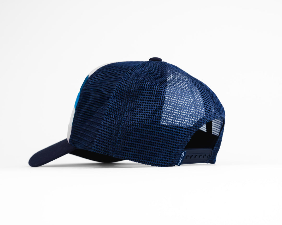 Swell Cap Blue: back view mesh cap with dark navy crown and light-blue stripe panels.