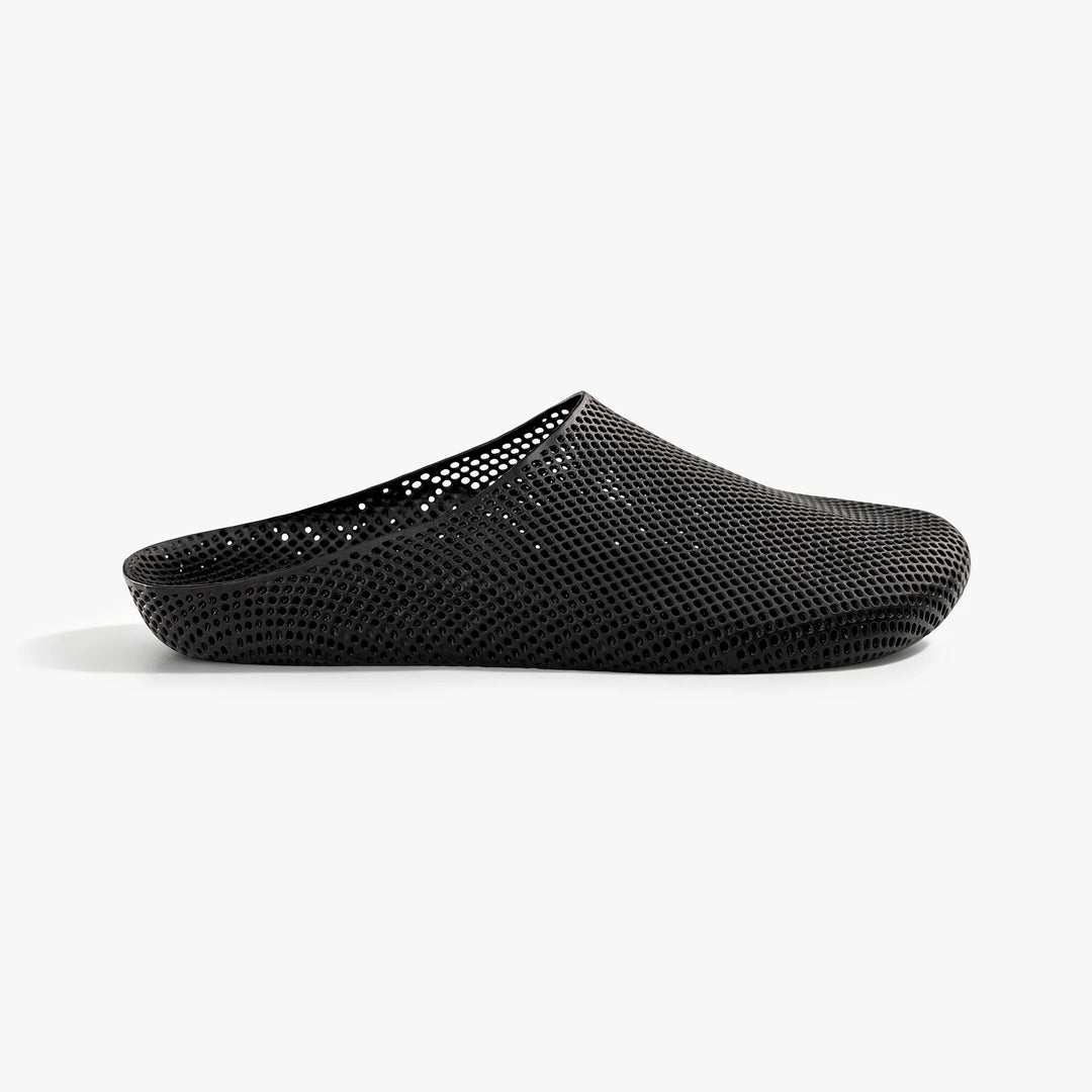 Black 3D-printed mesh slip-on slippers, side view.