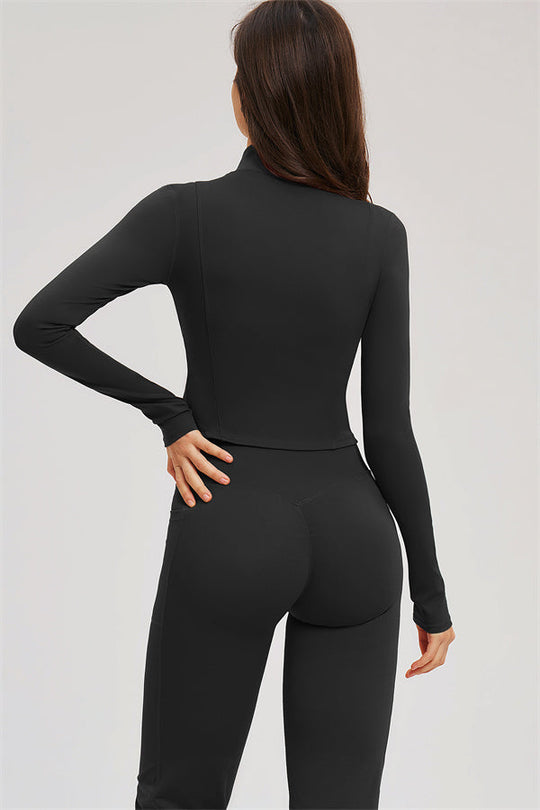 Black zip-front sports jacket and flared leggings from the back