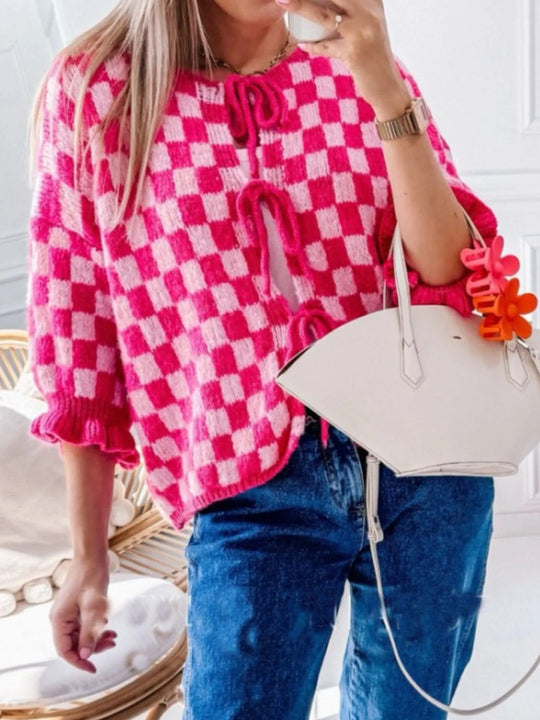 Hot pink checkered tie-front knit cardigan, drawstring neckline and flutter sleeve cuffs.