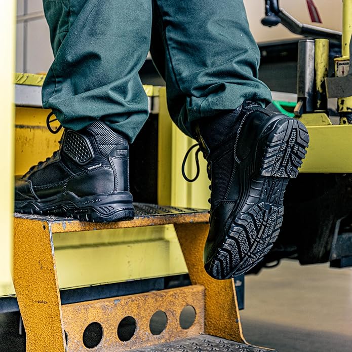 Black waterproof work boot worn on ankle with thick tread outsole
