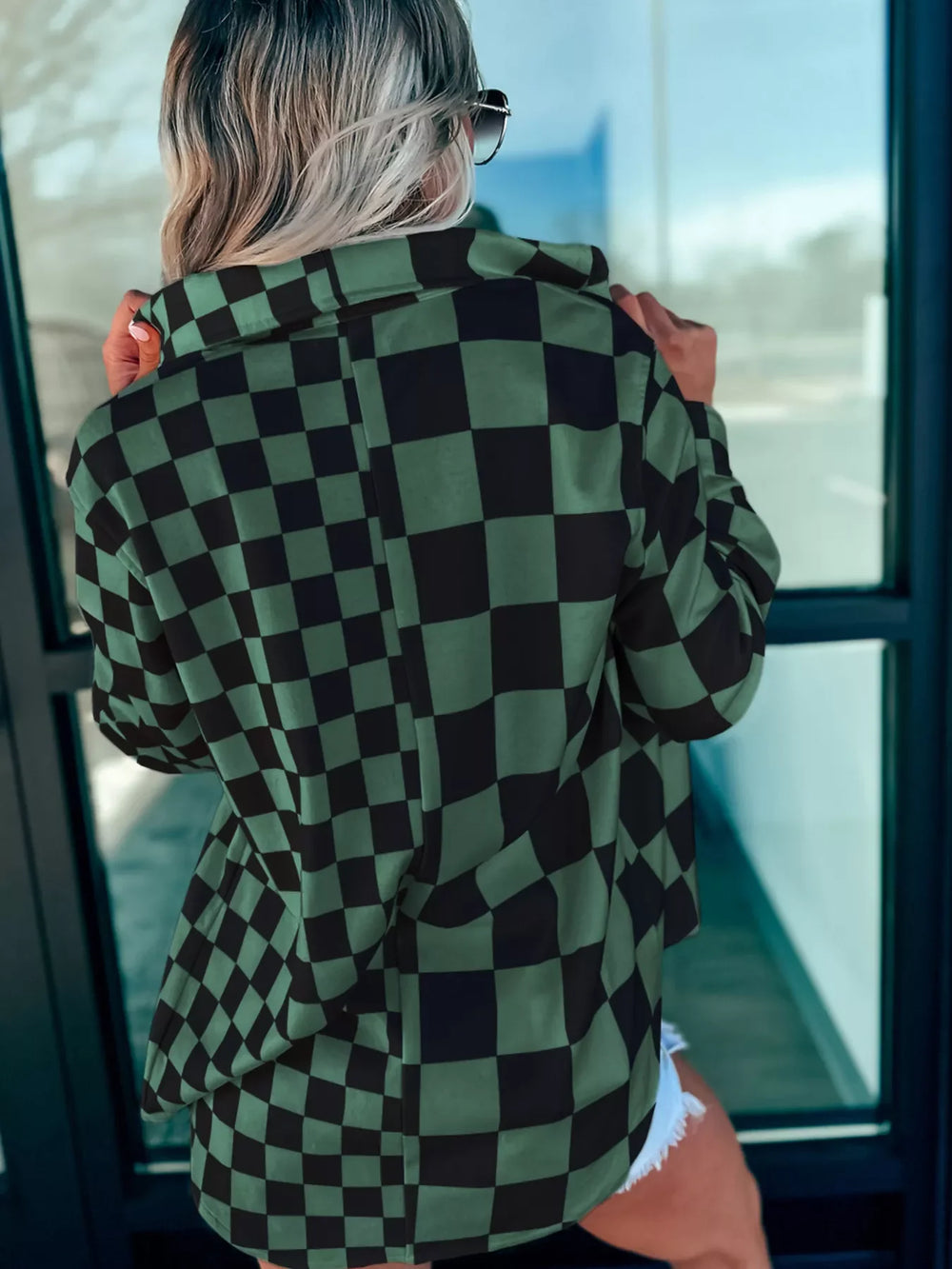 Back of dark green oversized checkered button-up jacket, full check pattern and yoke