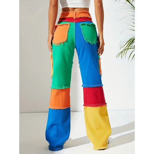 Front view patchwork denim jeans with colorful panels and frayed raw hems