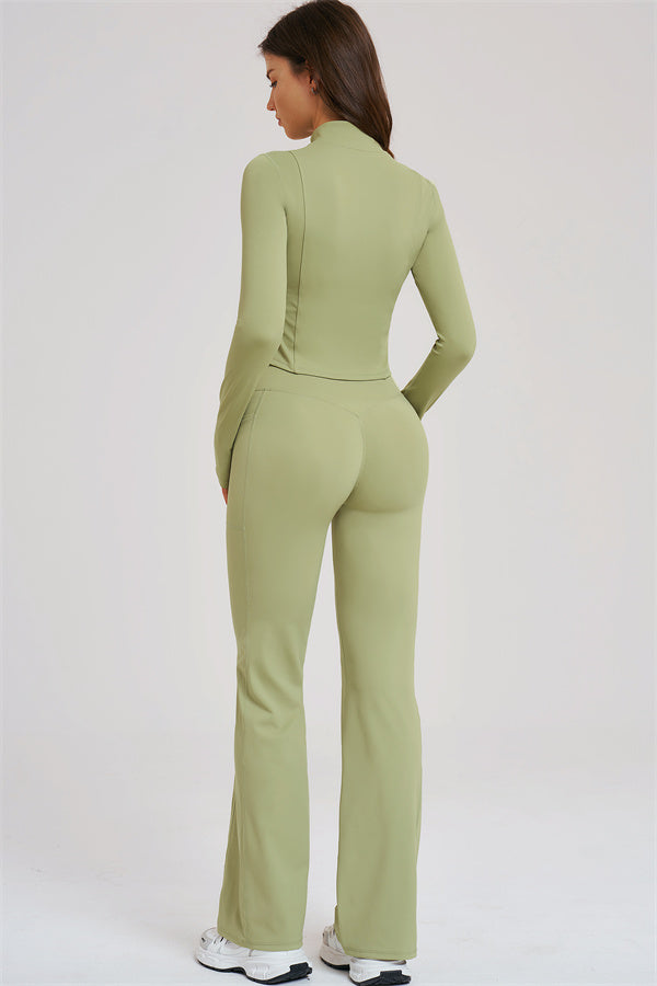 Olive green zip-front sports jacket and flared leggings from the back