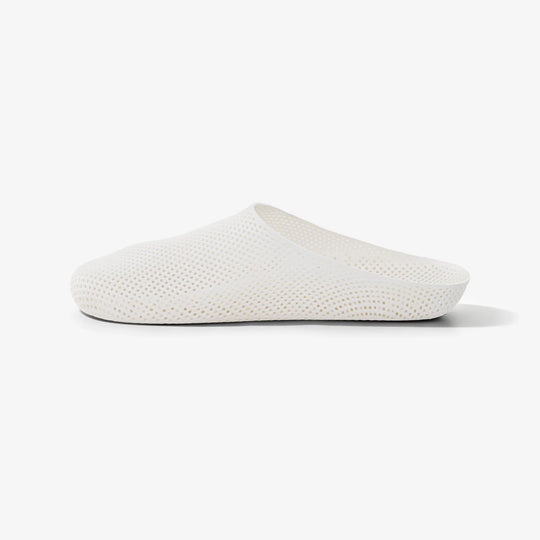 White 3D printed slippers with rounded toe, textured upper and slip-on collar.