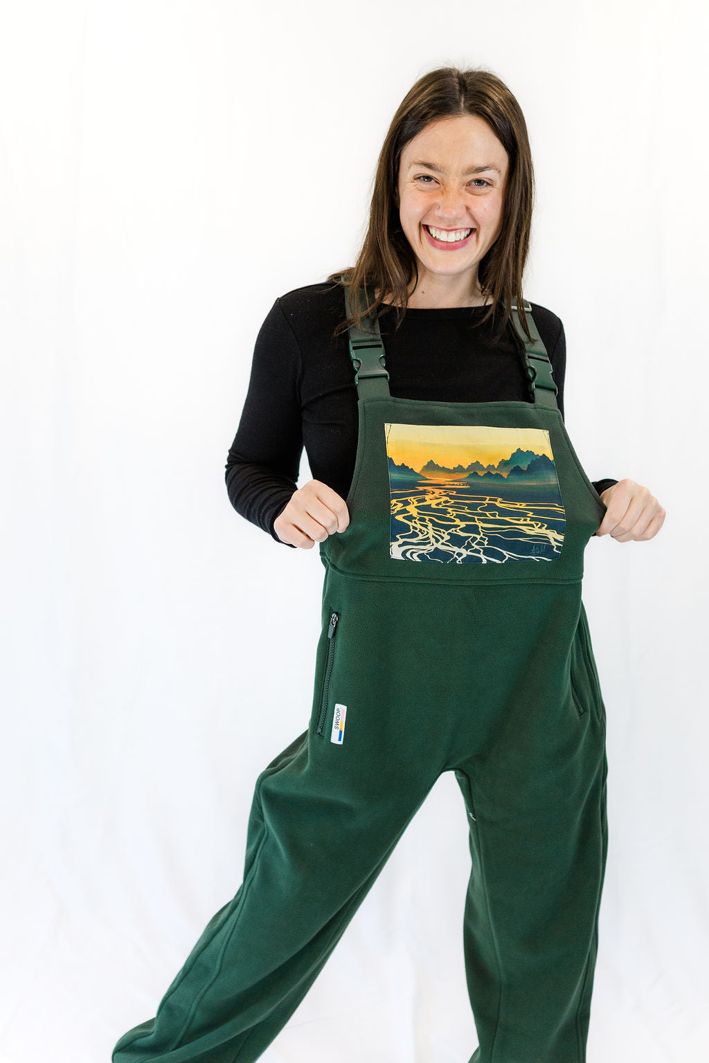 Braided River fleece overalls in dark green with front bib pocket and adjustable straps