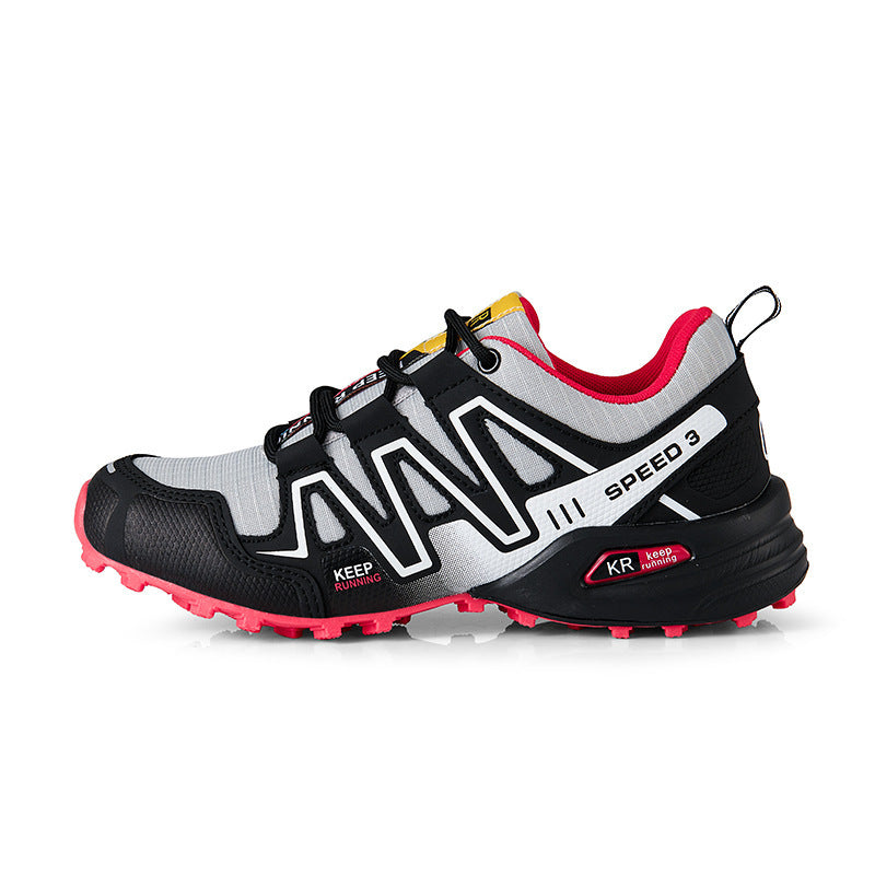 White and black trail shoe with pink outsole, lace-up front and side panels.