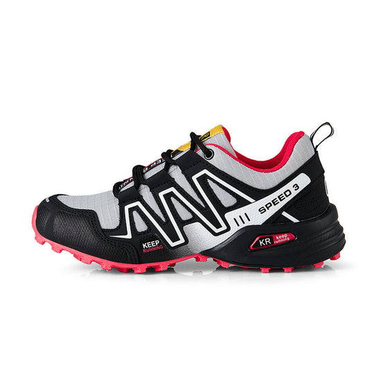 White and black trail shoe with pink outsole, lace-up front and side panels.