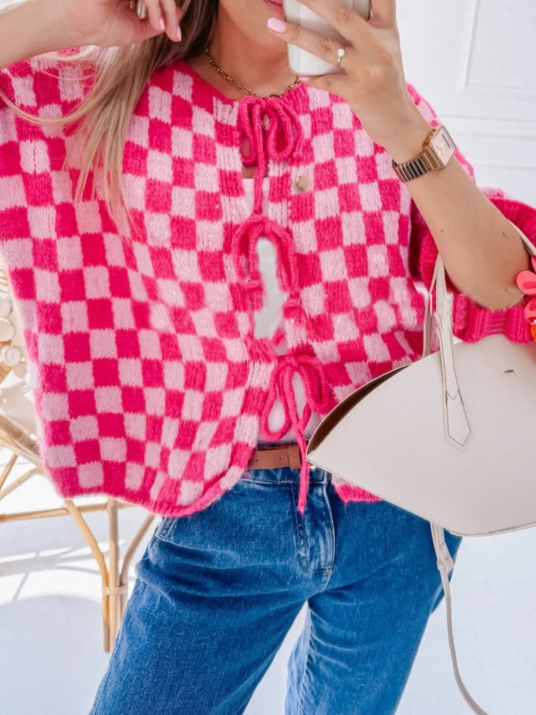 Hot pink checkered knit cardigan with tie-front detail and textured ribbed cuffs.