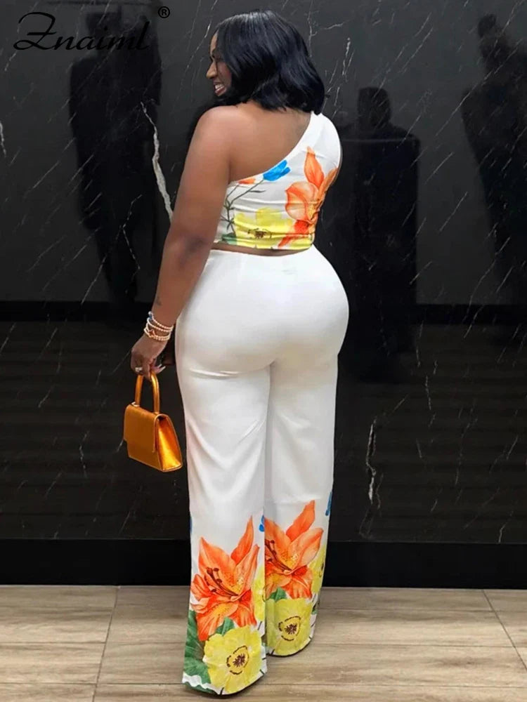 Back view: flower print wide-leg pants and one-shoulder crop top set, white base