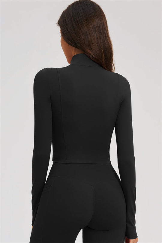 Black back view of zip-front cropped sports jacket with matching flared leggings