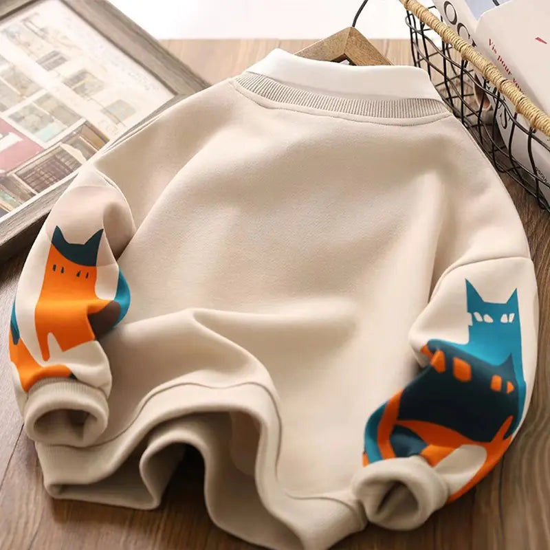 Beige kids long-sleeve hoodie with colorful cat graphic across the back