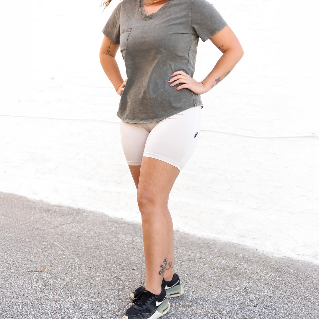 Clay light/cream biker shorts, fitted mid-thigh length with smooth waistband