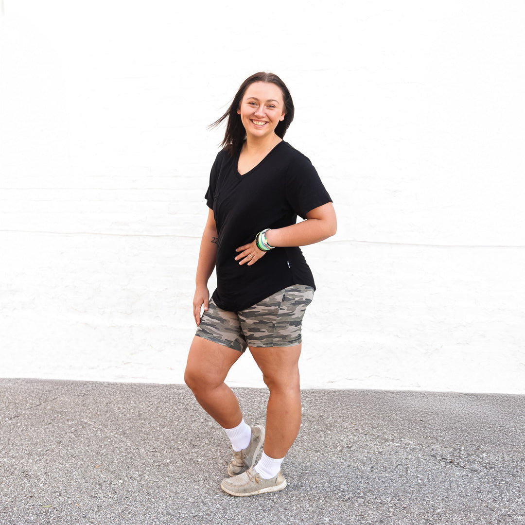 Dark camo biker shorts with fitted silhouette and mid-thigh length