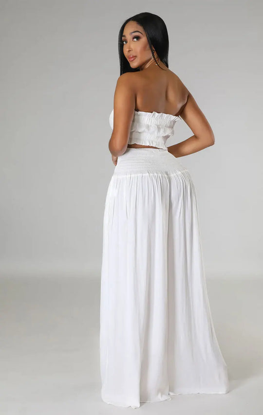 White smocked strapless bandeau crop top with high-waist flowy maxi wide-leg pants