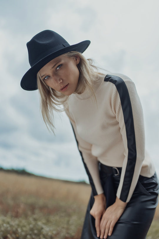 Ivory ribbed turtleneck sweater with black leather shoulder detail