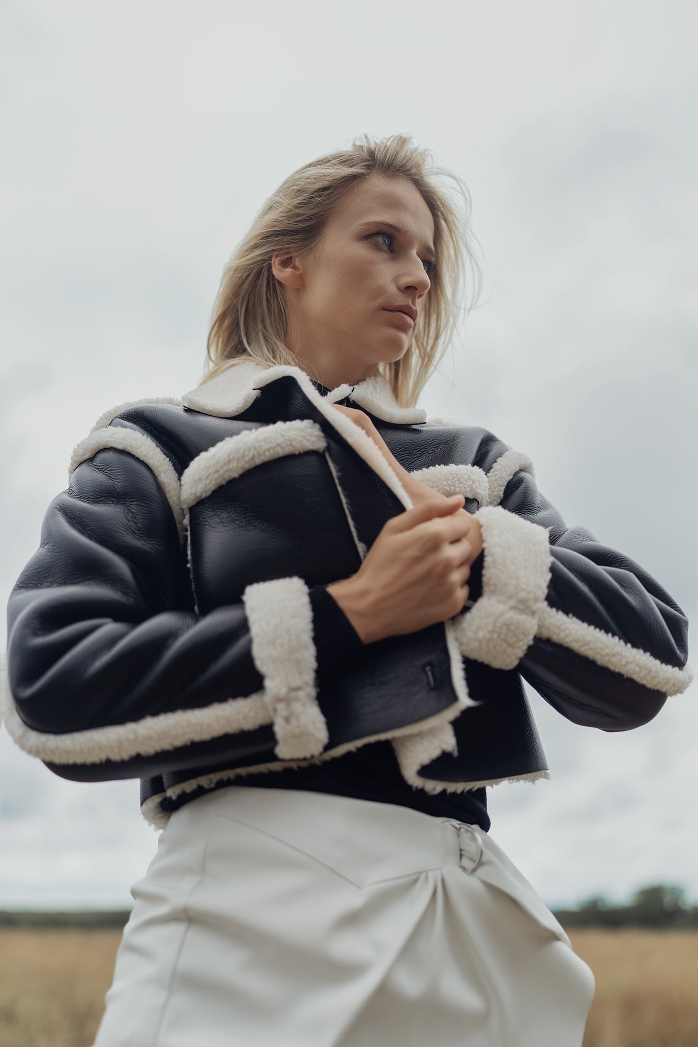 Black leather sherpa jacket with cream shearling collar and cuffs, button front