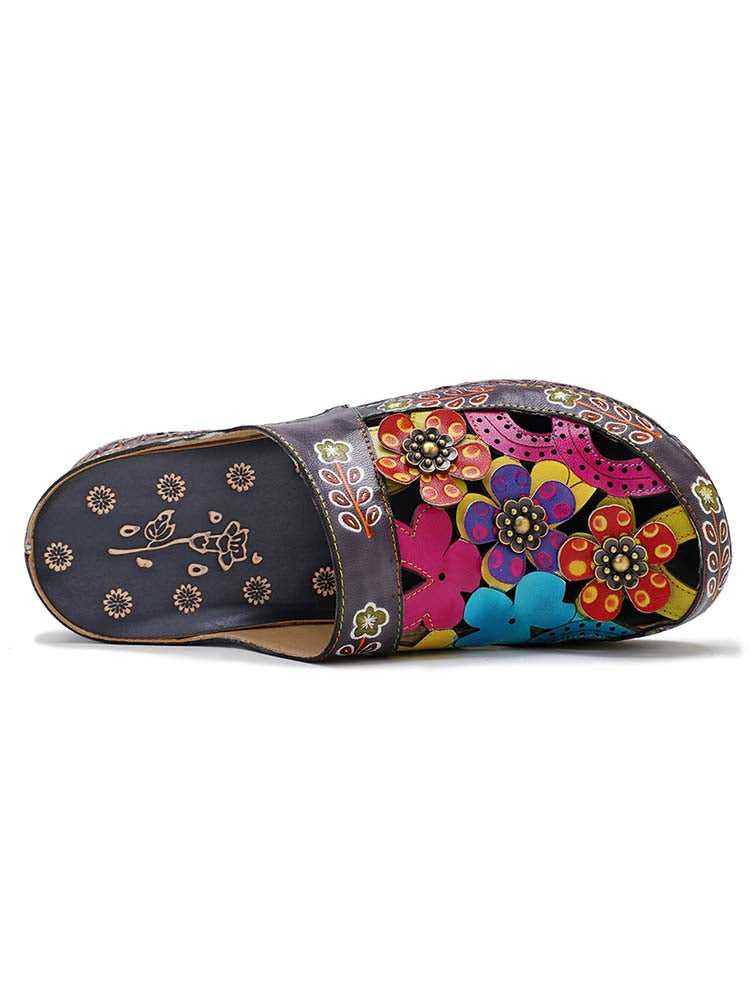 Floral slide slippers with open toe, dark base and colorful flower appliqués