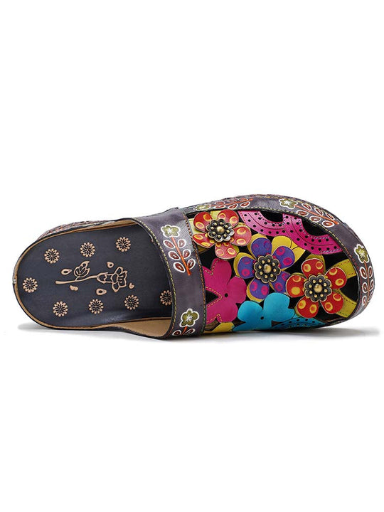 Floral slide slippers with open toe, dark base and colorful flower appliqués