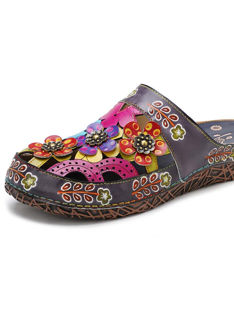 Dark floral slippers with bright flower appliqués and patterned decorative trim