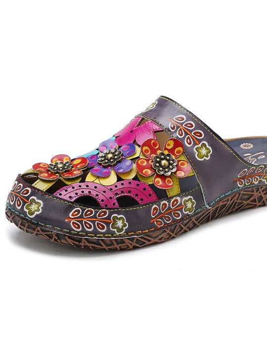 Dark floral slippers with bright flower appliqués and patterned decorative trim