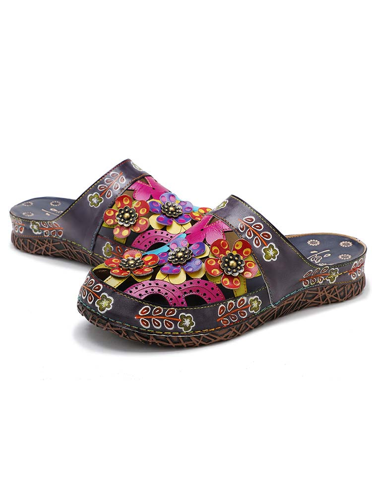 Handmade floral slippers with colorful blossoms on dark upper and flower-shaped details
