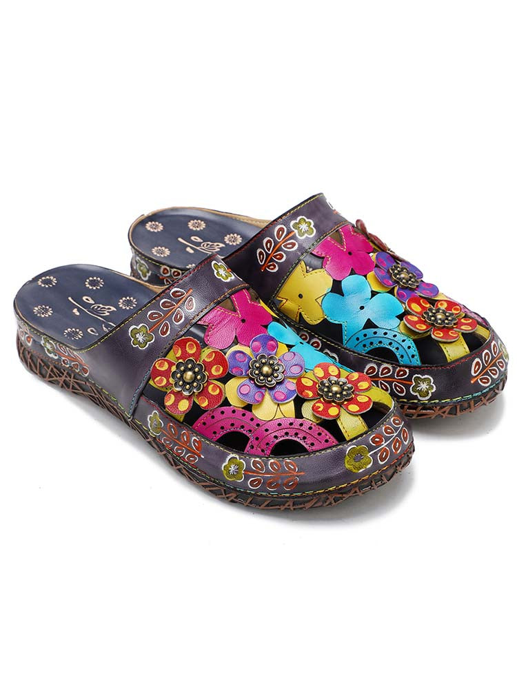 Floral mules with colorful flower patches and decorative bead flowers on dark fabric