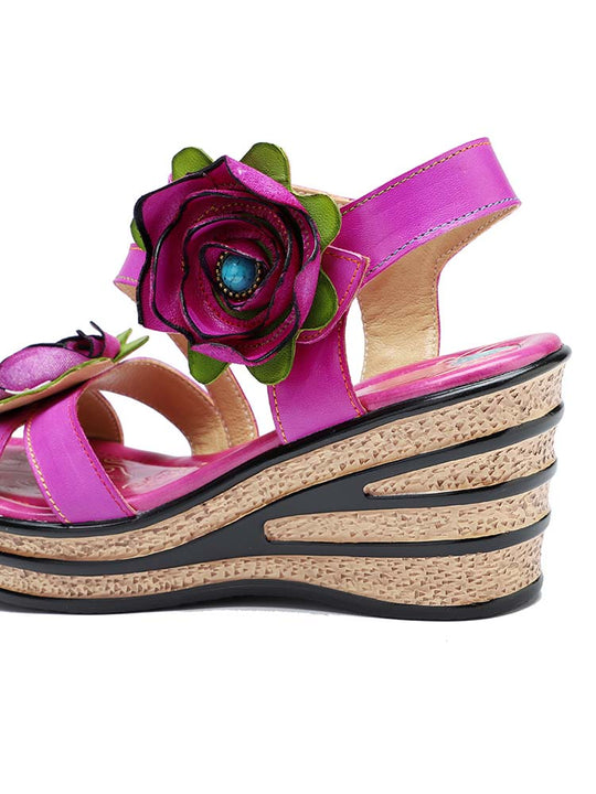 Close-up of pink wedge sandal with large rose detail and cork wedge platform edge