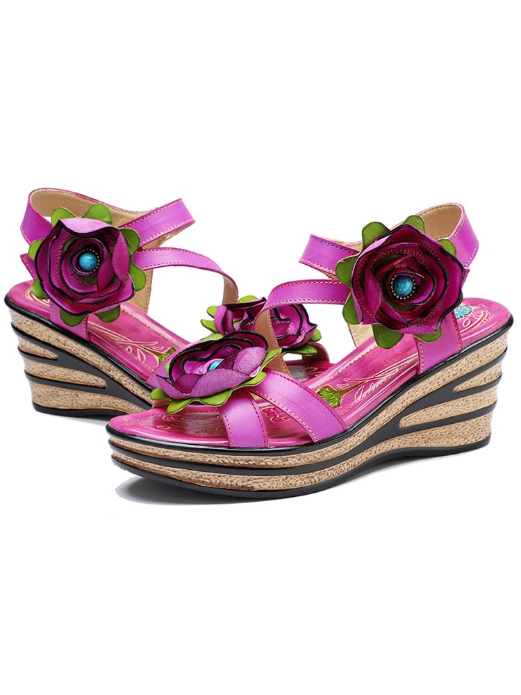 Pair of pink rose wedge sandals with two-tone flower details and cork wedge sole