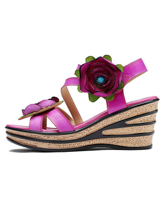 Pink rose wedge sandals with open toe and green leaf trim on the flower