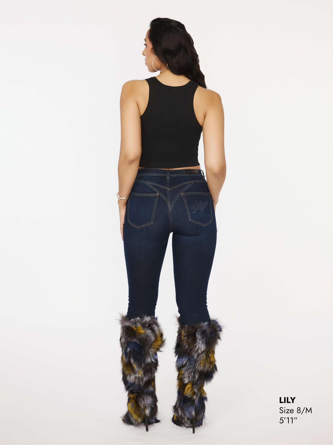 Dark blue skinny jeans back view with logo patch on the yoke