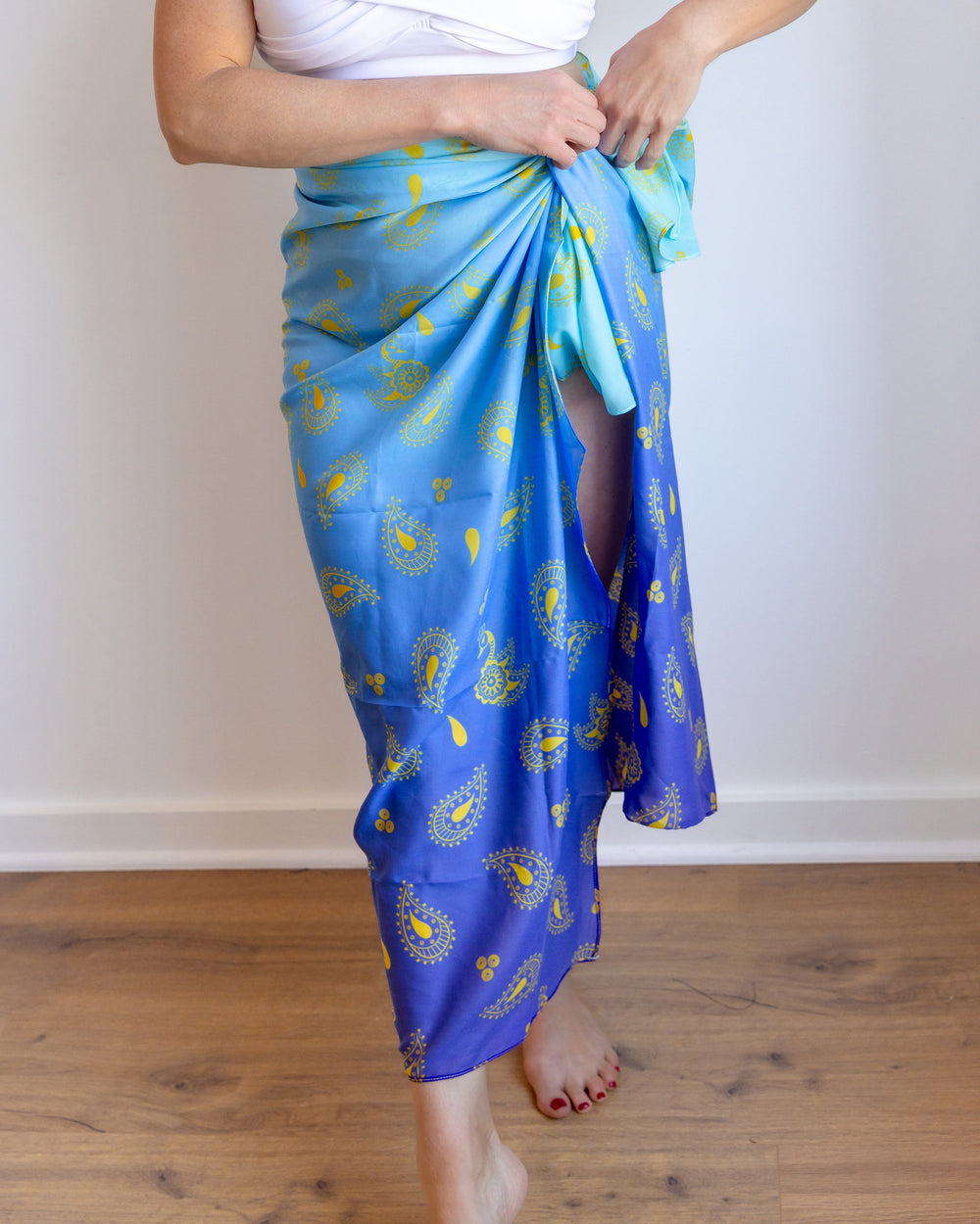 Blue wrap swim cover-up skirt with yellow paisley print, waist tie detail