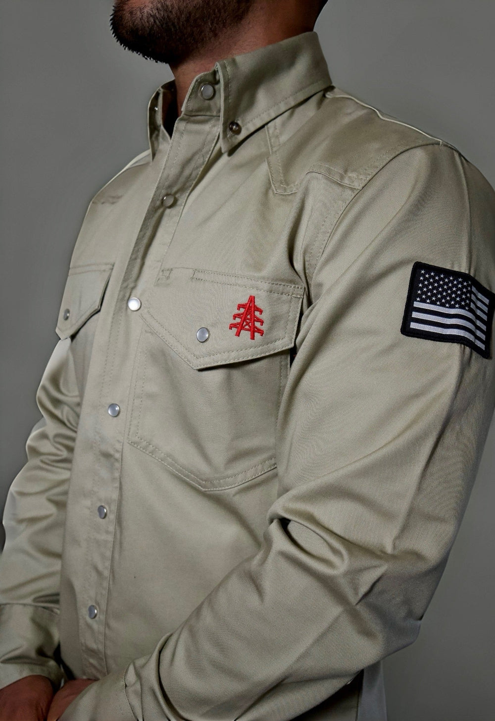 Khaki FR Western shirt close-up: pearl snaps, flap pocket, US flag sleeve patch