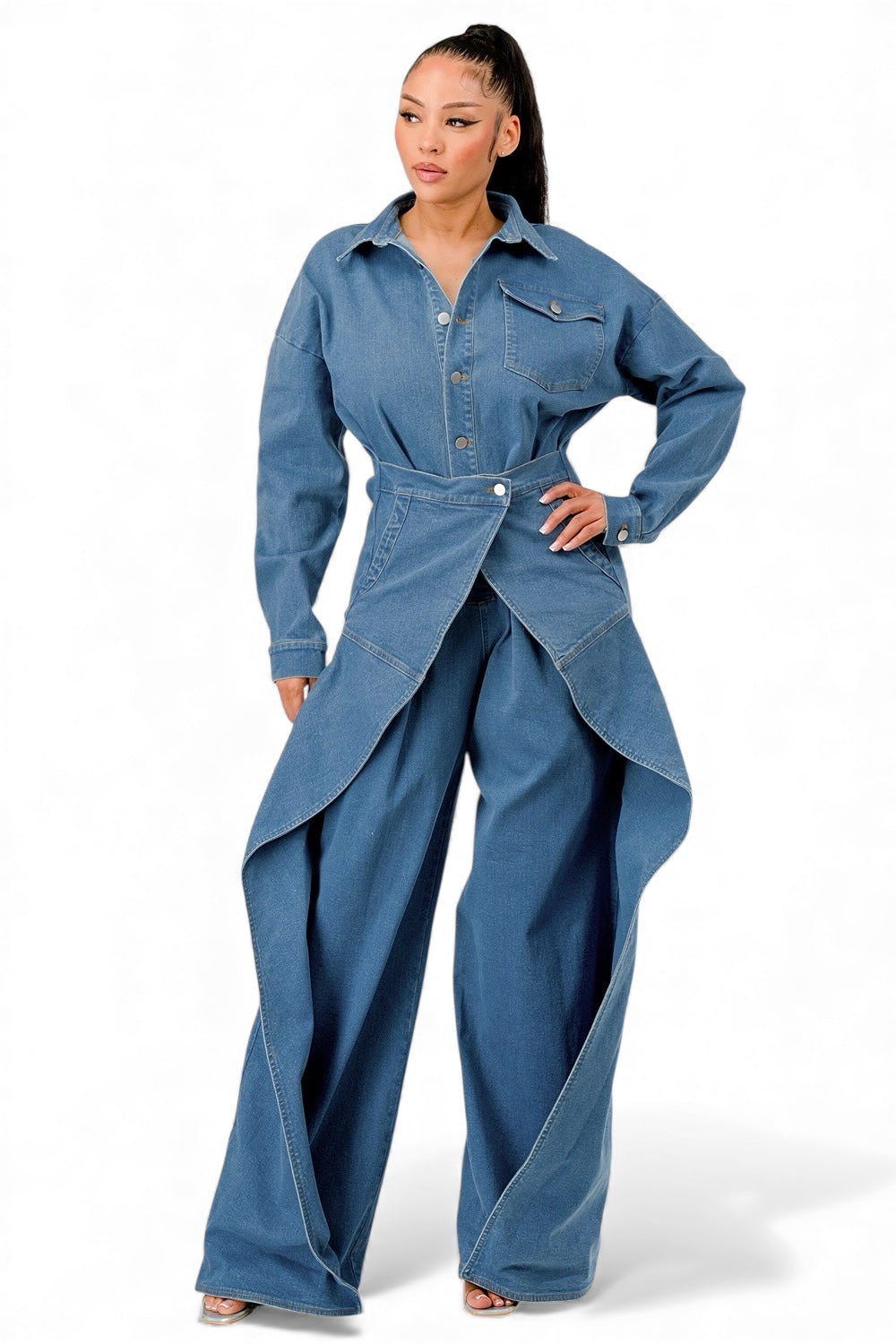 Denim jumpsuit with button-up top, chest pocket, waist belt, and asymmetric drape