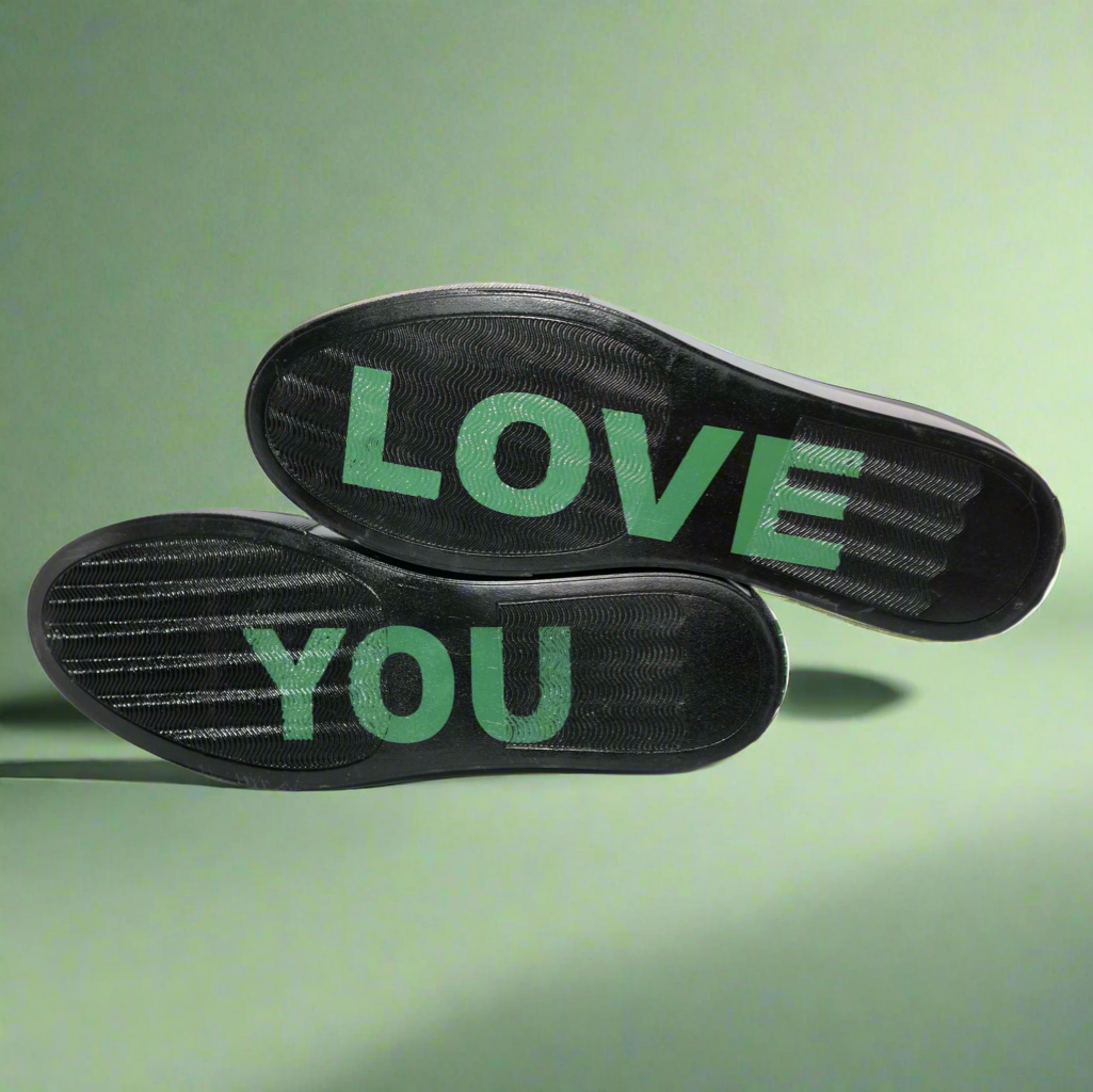 Sole views: black sneaker tread with green &