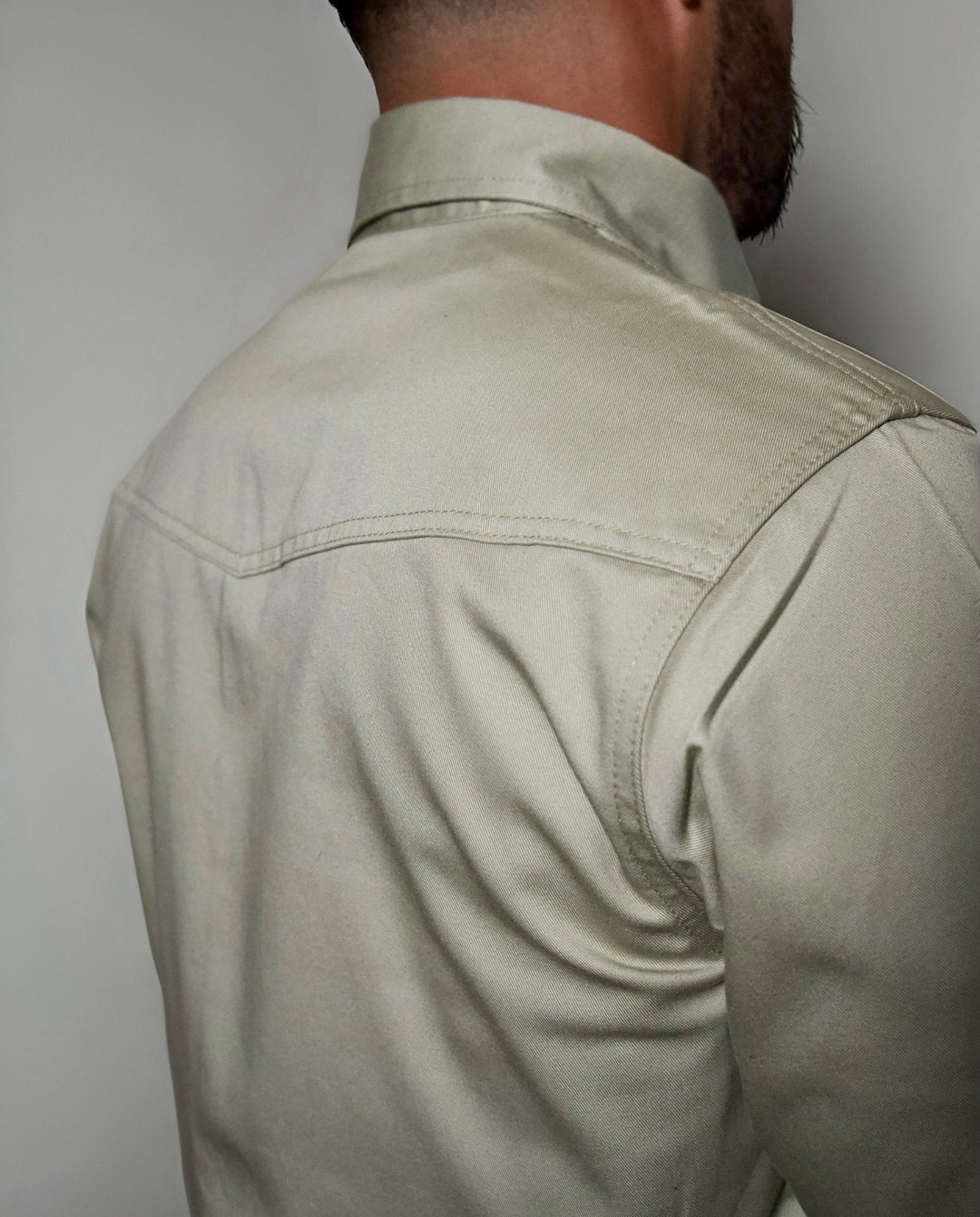 Khaki FR Western shirt back view with yoke seam and smooth shoulder
