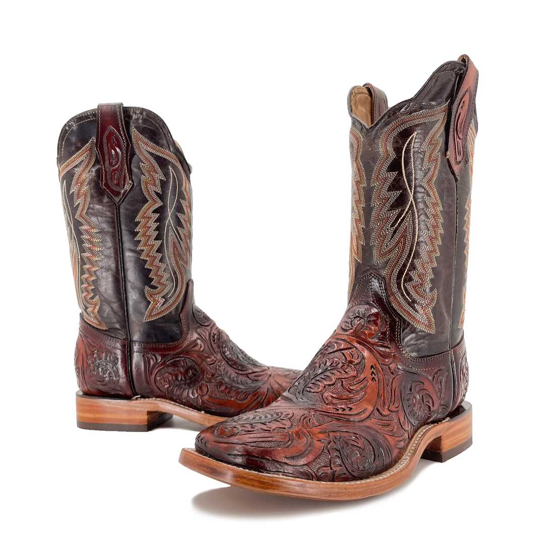 Cognac cowboy boots with dark shaft, hand-tooled floral toe and tan stacked heel