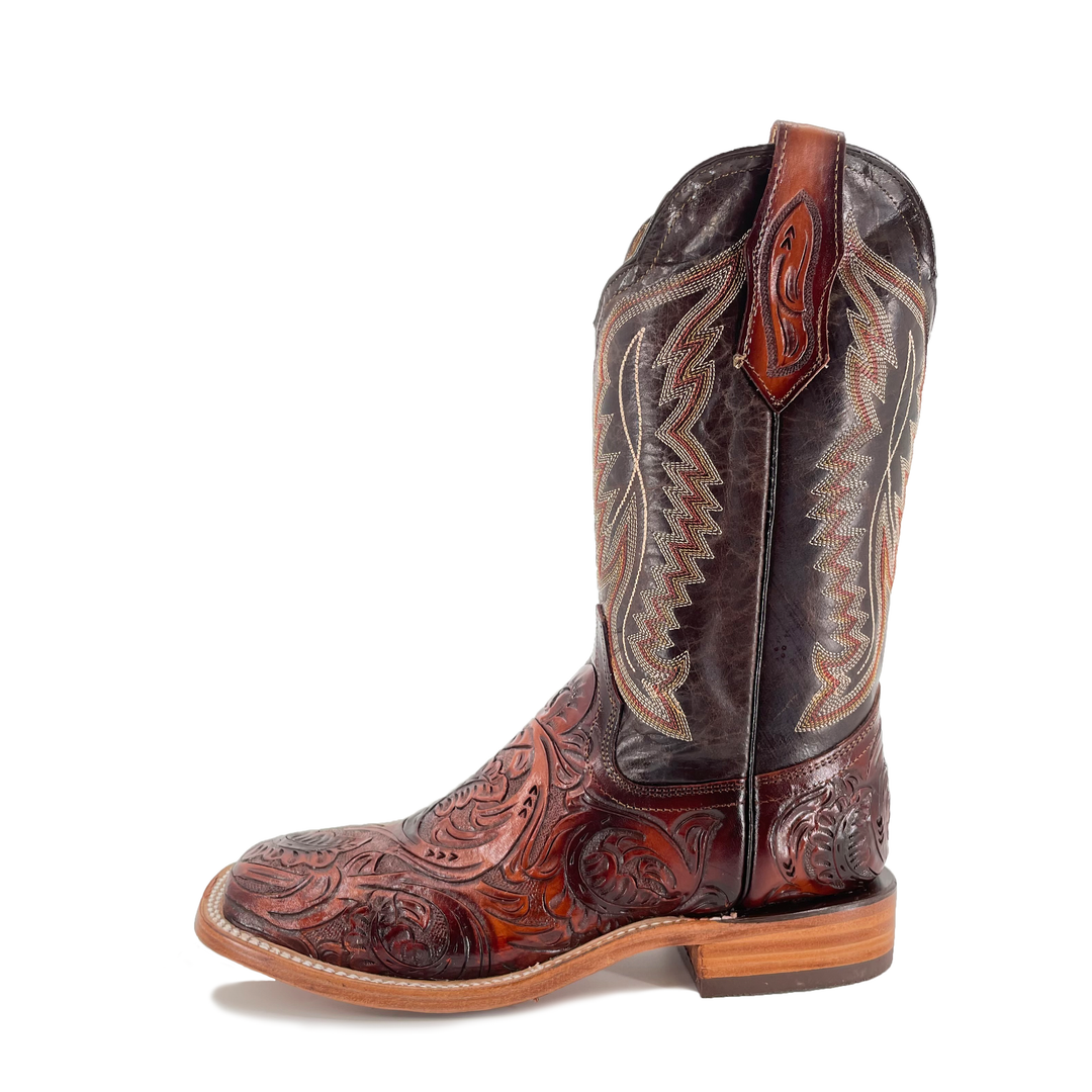 Cognac cowboy boot with dark upper, tall shaft and carved toe details