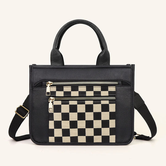 Black tote with checkerboard front insert, dual zip pockets, and crossbody strap