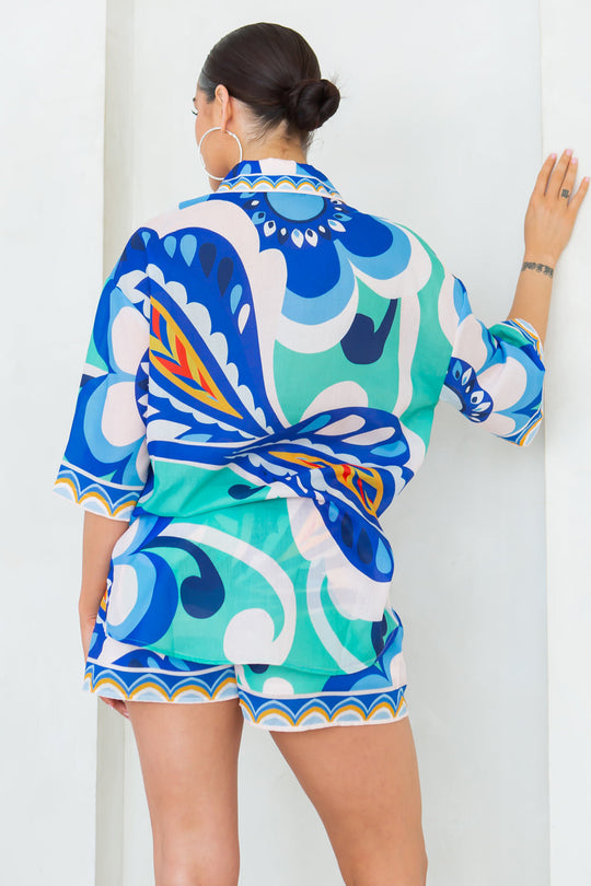 Back view of Joanna short set with blue, teal, and white abstract pattern; tie belt
