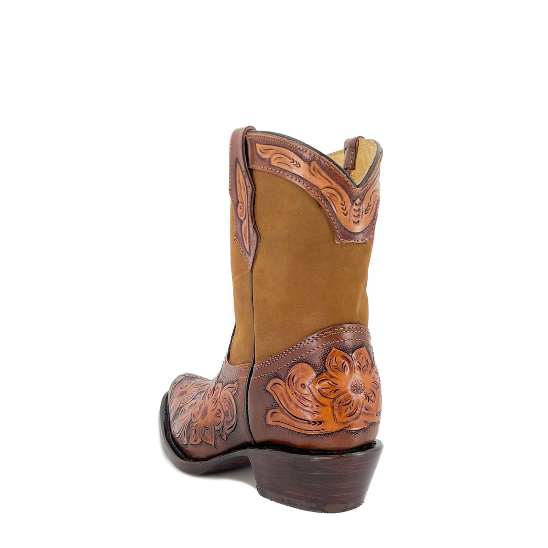Side view tan ankle bootie with carved floral panels and stacked dark heel